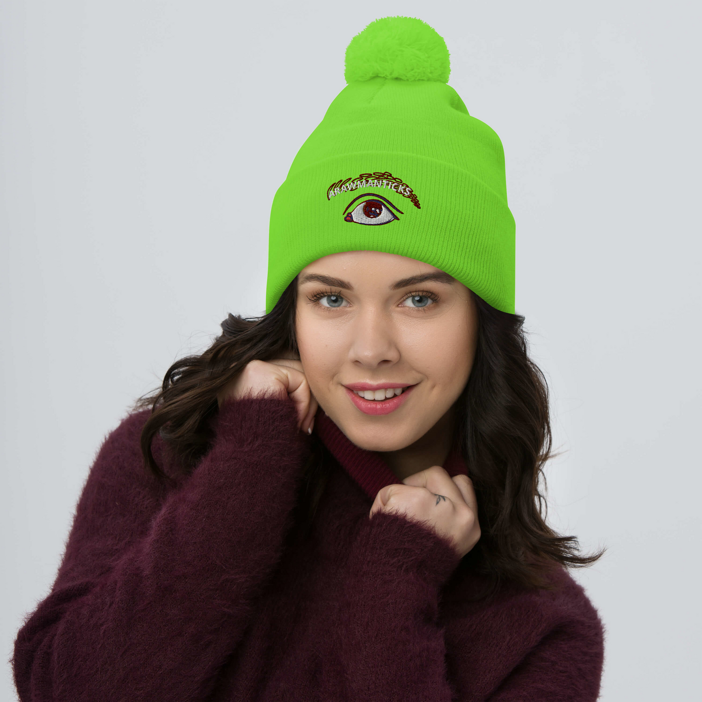 Female Model Wearing Neon Green Pom-Pom Beanie with Eye Embroidery - ARAWMANTICKS